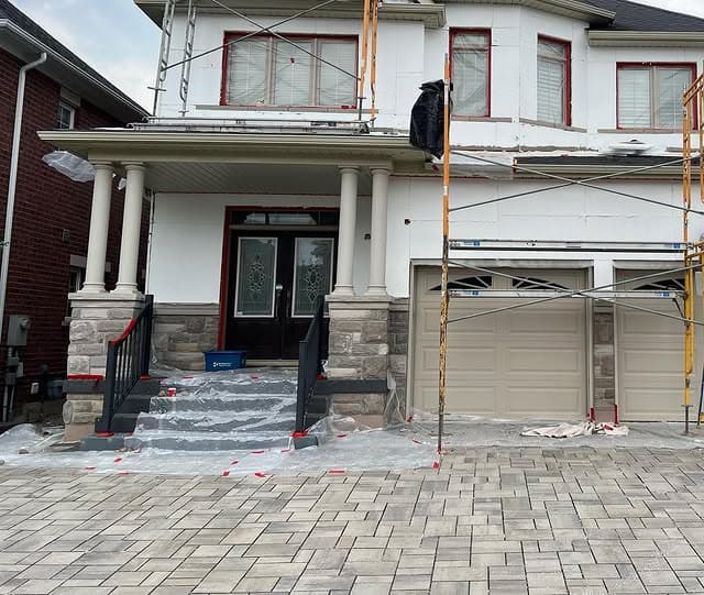 Completed residential stucco elevation with trims and clean detailing by Ozwan Stucco
